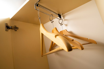 modern clothes hangers on rings in a closet with a sliding system