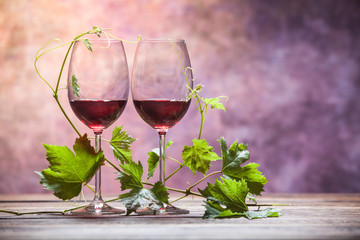 Heart-shaped leaves around two glasses of red wine