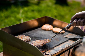 grilling burger patties on the grill