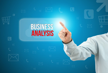 Business man touch a button on an imaginary screen with text BUSINESS ANALYSIS