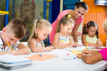 Fototapeta premium Careful children drawing on lesson in class room