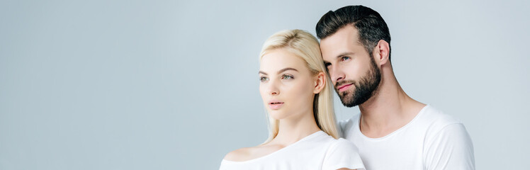 panoramic shot of man and young woman in white T-shirts isolated on grey with copy space