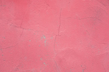 Wall fragment with scratches and cracks. Concrete weathered pink wall