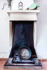 CHIMNEY WITH METAL PAN, SCISSORS AND IRON CHAINS. RURAL KITCHEN