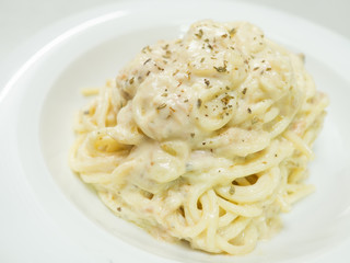 Pasta Carbonara with tuna on a white plate