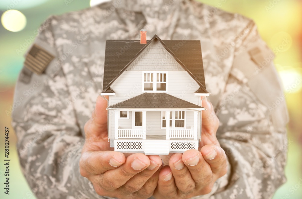 Canvas Prints Soldier Holding a Model of House