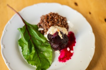 Beetroot, quinoa and leaf on plate.