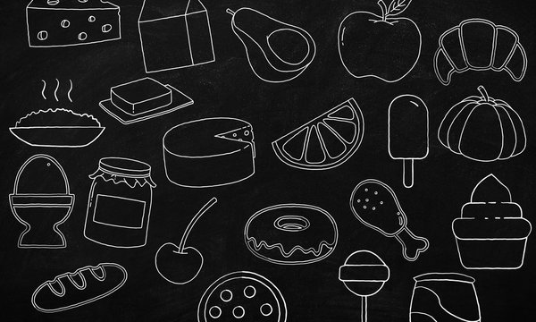 Hand drawn doodles of cartoon food in a blackboard