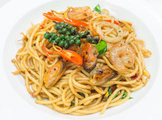 Spaghetti spicy with seafood on a white plate