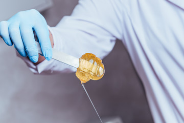 depilation and beauty concept - sugar paste or wax honey for hair removing with wooden waxing...
