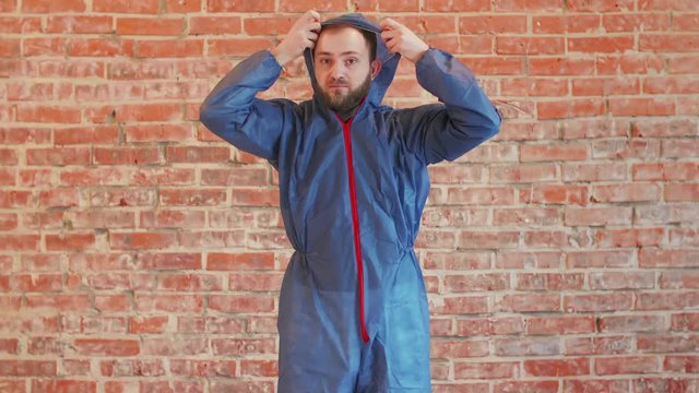 Young bearded man wearing blue protective workwear