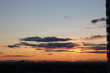 sunset over city. orange sunset in a big city.  Summer sunset.  crimson sky colors.  color evening evening sky. Summer sunset