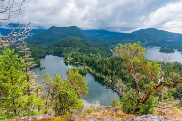 Fototapeta na wymiar View at Mountain Lake with Dramatic Clouds in British Columbia, Canada.