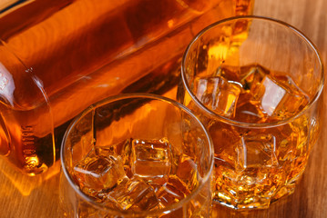 Still life. Whiskey in to glass. Wooden table