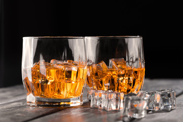 Still life. Whiskey in to glass. Wooden table