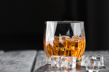 Still life. Whiskey in to glass. Wooden table