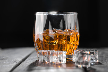 Still life. Whiskey in to glass. Wooden table