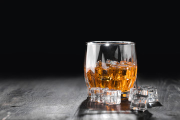 Still life. Whiskey in to glass. Wooden table