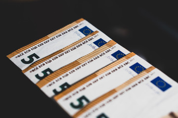 Stack of Euro banknotes (€) on dark background - Closeup on 50 EURO banknots.
