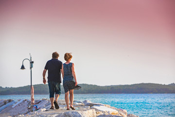 Croatia, Istria, couple enjoying sunset on the pier
