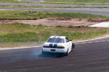 Obraz na płótnie Canvas racing car in a skid. drift, tire smoke. sports car. extreme sport