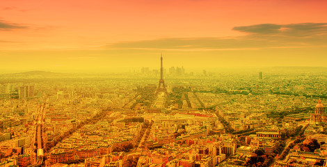 eiffel tower and bright sun on orange - heat wave in Paris, France
