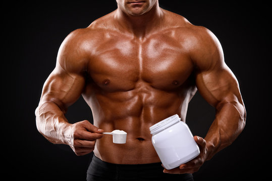 Close up of Muscular Men Taking Nutritional Supplements