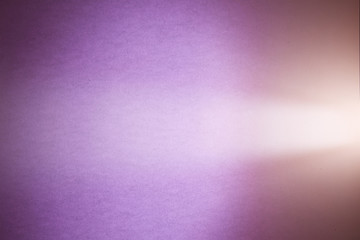 Purple textural and dark creamy blurred background cuts the light beam of light