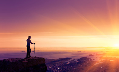 Silhouette Of Man With Hiking Pole On The Top Of Mountain At Sunrise Light, Lofoten Islands, Norway
