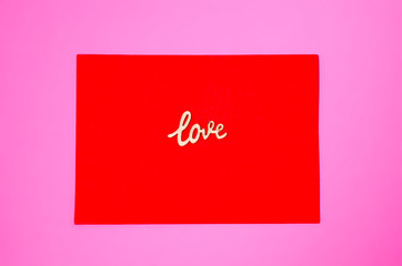 Red envelope on pink background. Sign love. Love concept. Love letter. Paper craft.