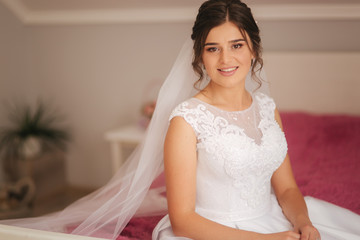 Charming bride stand in front of window. Girl stand by the window at her room. Black and white. Silhouette