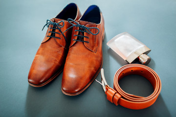Businessman's accessories. Brown leather shoes, belt, perfume. Male fashion. Businessman