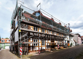 Reconstruction and renovation of an old half-timbered house. Scaffolding on half-timbered house