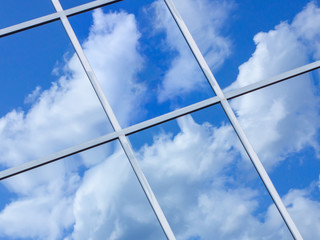 bright blue cloudy sky in n window reflection
