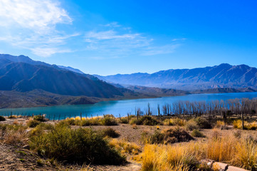  Landscape in Mendoza, Argentina. Lake with mountains in the background. Road to Chile.