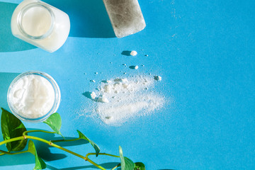skin care with natural products baking soda,  coconut oil,  salt soap top view on bright blue background