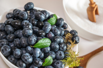 Blueberry and sugar in a bowl in the kitchen.