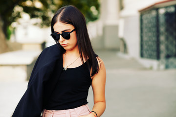 Obraz premium beautiful girl with beautiful girl with brunette hair, posing outside, hipster style, portrait, black jacket, brash girl, sunglasses, street, backpack, Fall fashion