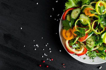 Vegetables on the plate. Sliced vegetables salad for a healthy diet. Top view. Background with place for text. Close up