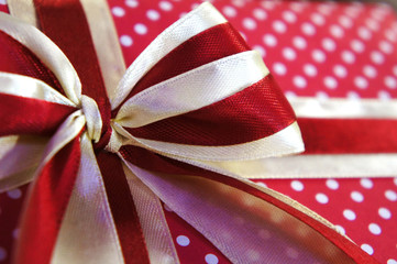 red gift bow close-up. holiday gift close-up. white polka dots