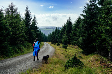 Young woman on the trail in Giant Mountains (Karkonosze), authentic travel experience. 