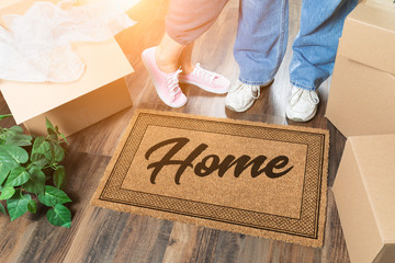 Man and Woman Unpacking Near Home Welcome Mat, Moving Boxes and Plant