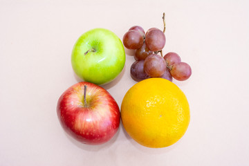 Two apples, grapes and an orange seen from above