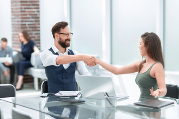 handshake business partners at the office Desk
