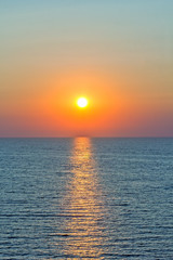 Scenic sunset and sun path in the blue sea