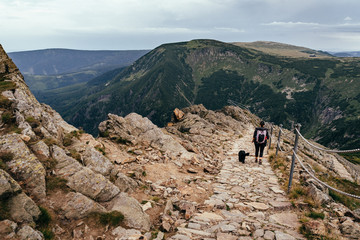 Young woman on the trail in Giant Mountains (Karkonosze), authentic travel experience. 