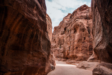 Jordan canyon narrow path way between rocks scenic landscape near national park Petra heritage destination for tourism and sightseeing 