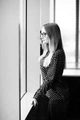 business woman standing near window in office