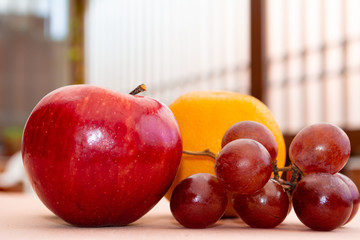 Red apple, orange and grapes from close up