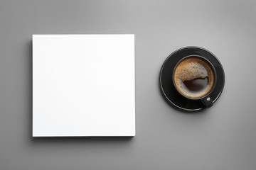 Obraz na płótnie Canvas Blank paper sheets for brochure and cup of coffee on grey background, flat lay. Mock up
